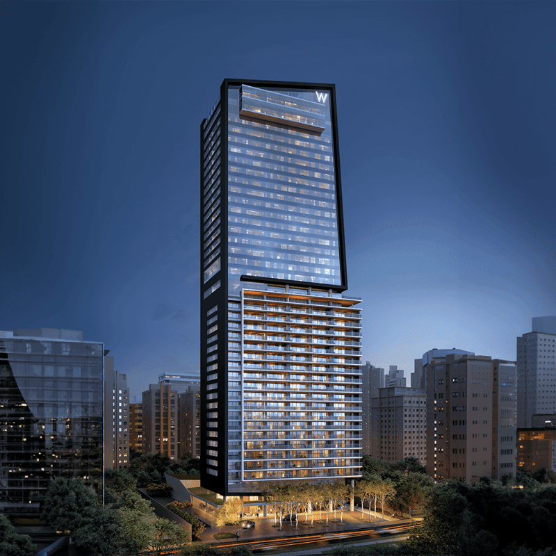 Fachada noturna de torre alta com arquitetura contemporânea e iluminação integrada nos andares.